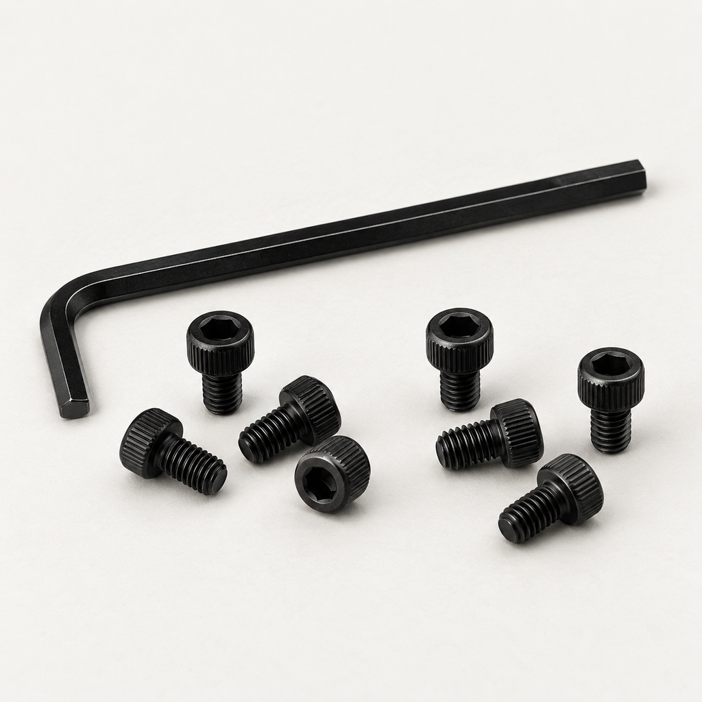 Eight black M3 socket head screws scattered in front of a black 2.5 mm hex key, shown at an angle