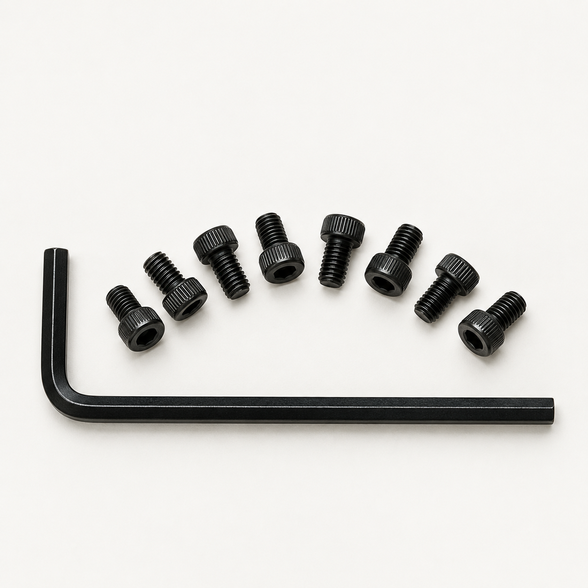 Eight black M3 socket head screws arranged in an arc above a black 2.5 mm hex key