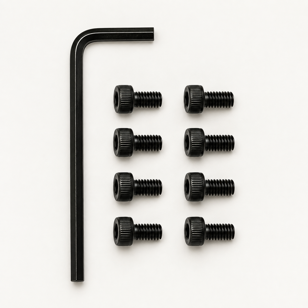 Slabster EXO Hardware Kit: one black 2.5 mm hex key beside eight black M3 socket head screws laid out in two rows of four