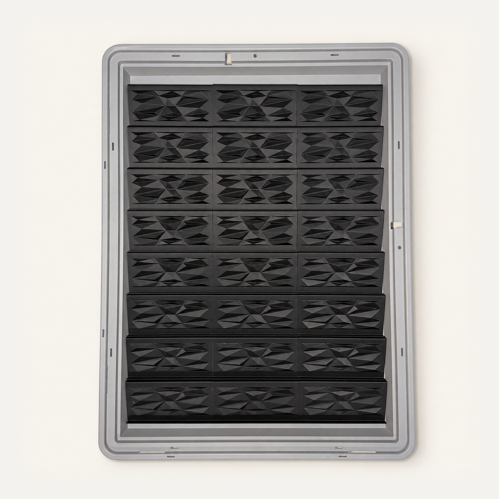 Top-down view of 24 black faceted risers in three columns inside a gray Zion display case