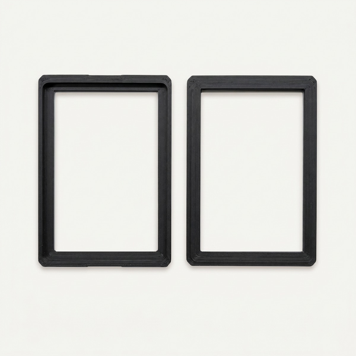 Black toploader guard opened into its two halves, showing the inside of each half