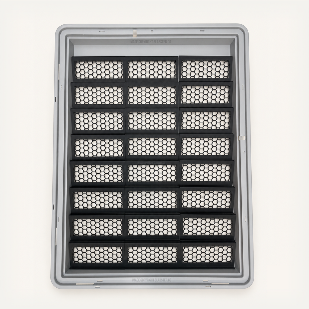Top-down view of 24 black honeycomb risers in three columns inside a gray Zion display case