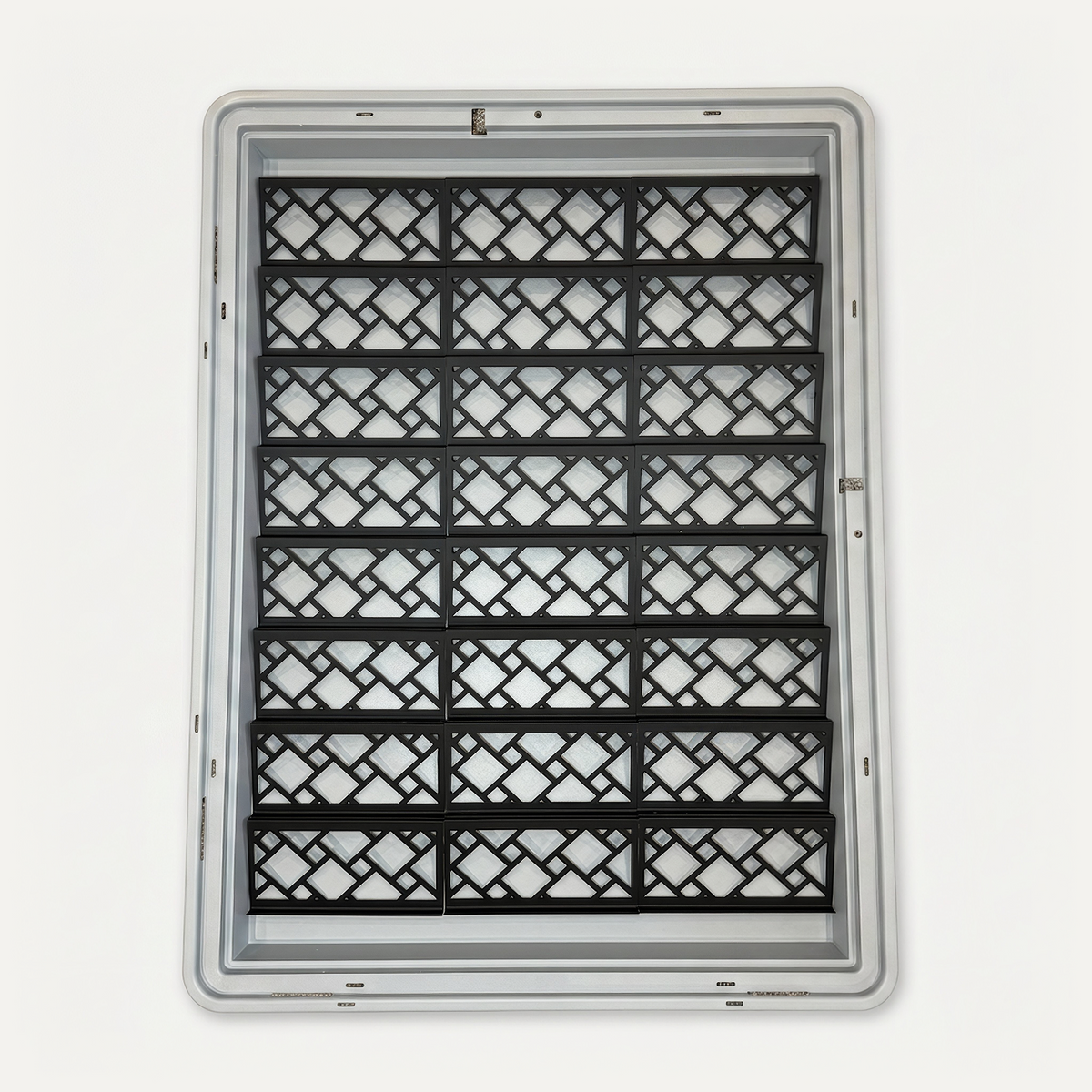 Top-down view of 24 black Featherlite risers with an open lattice pattern inside a gray Zion display case